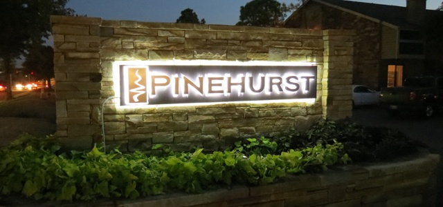Photo of the custom logo monument sign designed by Electremedia for Pinehurst Apartments in Oklahoma City.