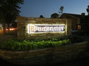 Photo of the illuminated monument sign Electremedia designed for Pinehurst Apartments.