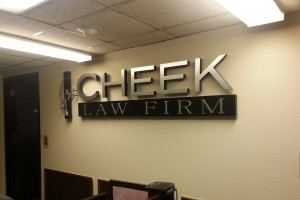 The lobby logo sign for Cheek Law Firm after installation.