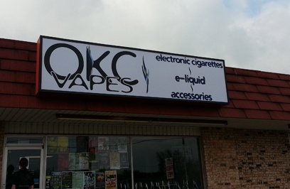 Image of OKC Vapes sign on building.