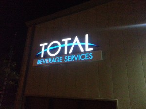 Picture of a channel letter logo sign at night after installation.