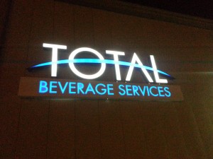 Nighttime picture of illuminated channel letter logo sign.