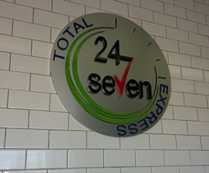 Photo of an interior logo sign on tile wall.