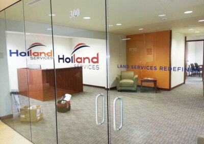 Glass and wall images of graphics for Holland Services.