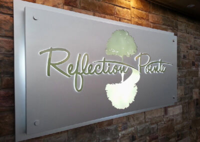 Multi-layered illluminated specialty wall sign.