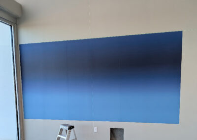 A lighter to darker blue gradient wall wrap for an acrylic display.