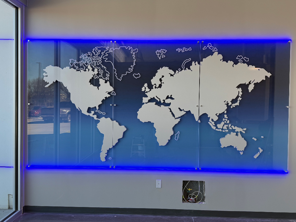 Image of a 3 panel acrylic wall display with vinyl graphics of the world continents.
