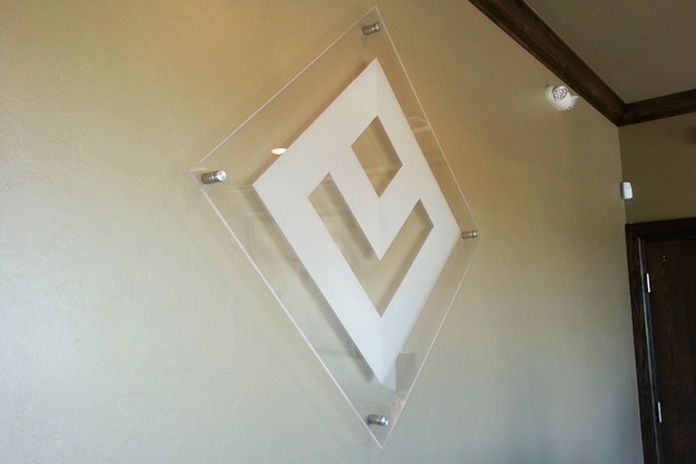 Photo of diamond shaped acrylic wall sign.