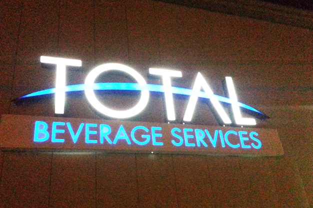 Photo of channel letter sign illuminated at night.