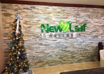 Picture of a New Leaf Wellness logo sign installed into their lobby.