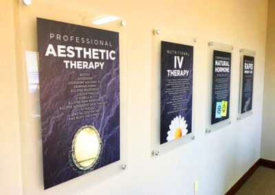 Image of 4 digitally printed acrylic posters installed to the wall with silver barrel offsets.