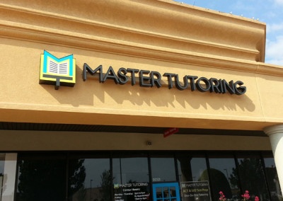 Photograph of channel letter sign outside on wall that says Master Tutoring, and has their logo on the left.