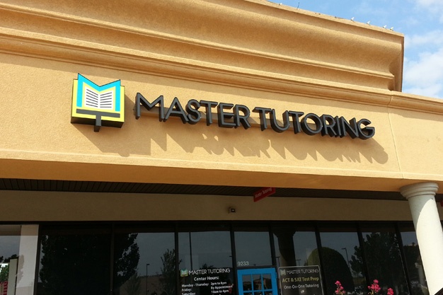 Photograph of channel letter sign outside on wall that says Master Tutoring, and has their logo on the left.