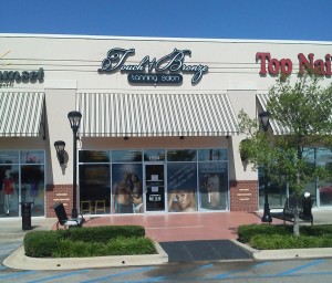A photograph of a tanning salon logo sign after installation.
