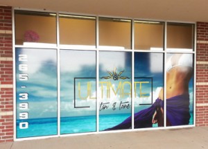 A picture of a vinyl window mural spanning 5 storefront windows.